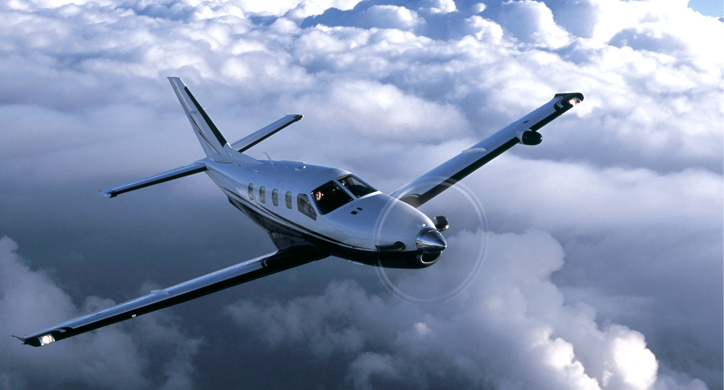 Socata TBM 700 flying above the clouds
