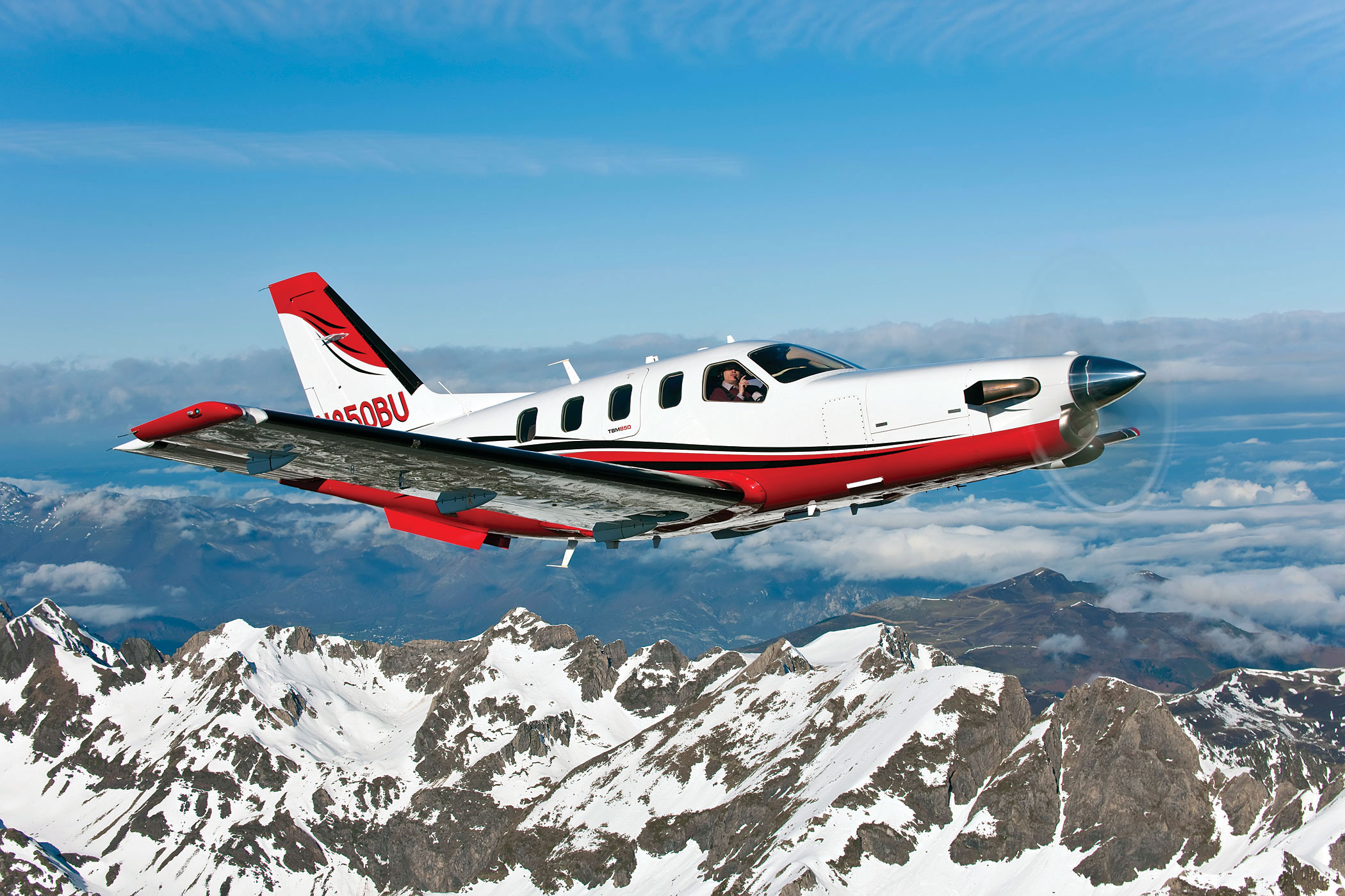 Socata TBM 850 flying above mountains