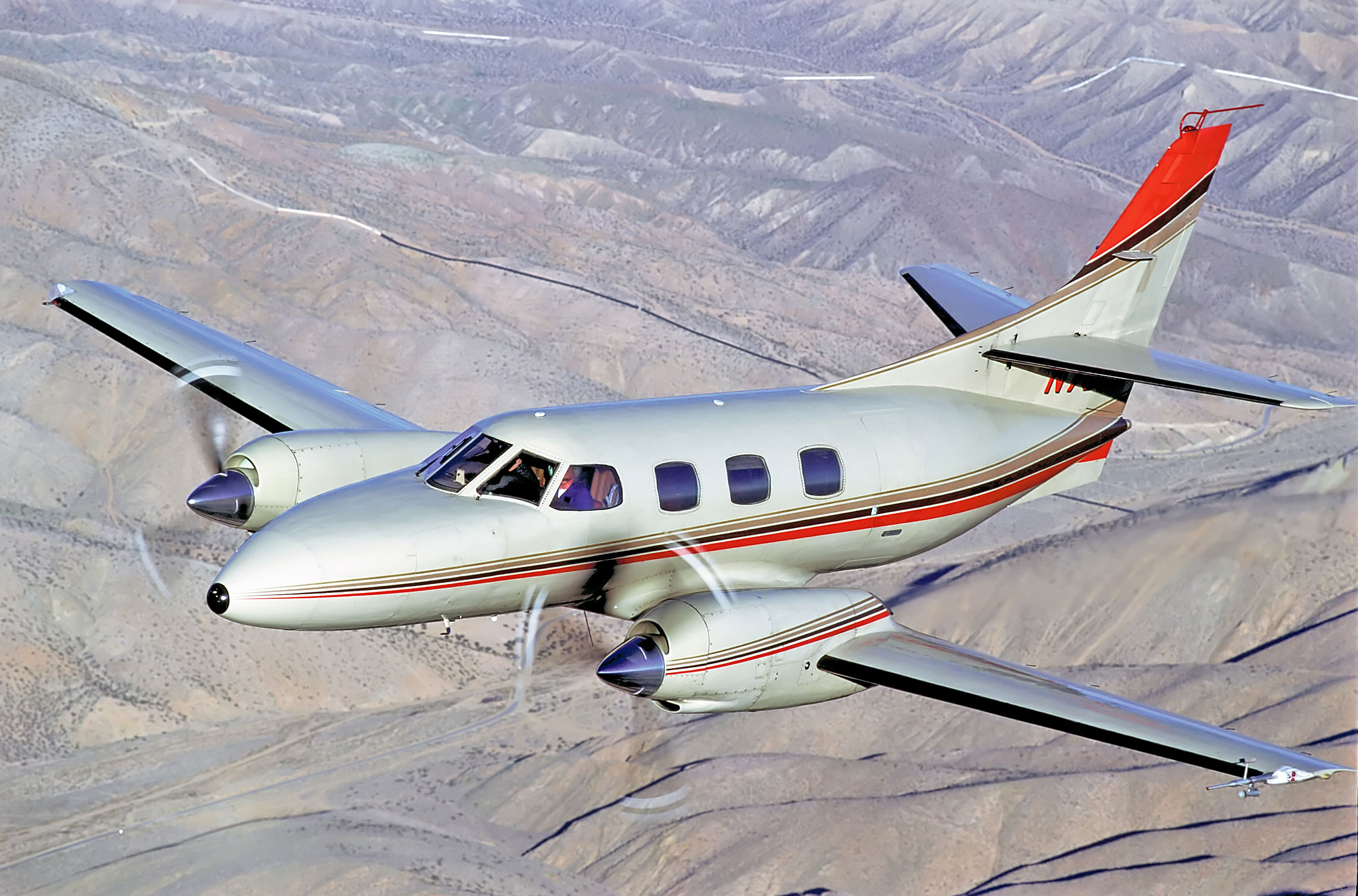 Swearingen Merlin SA226 airplane flying above mountains