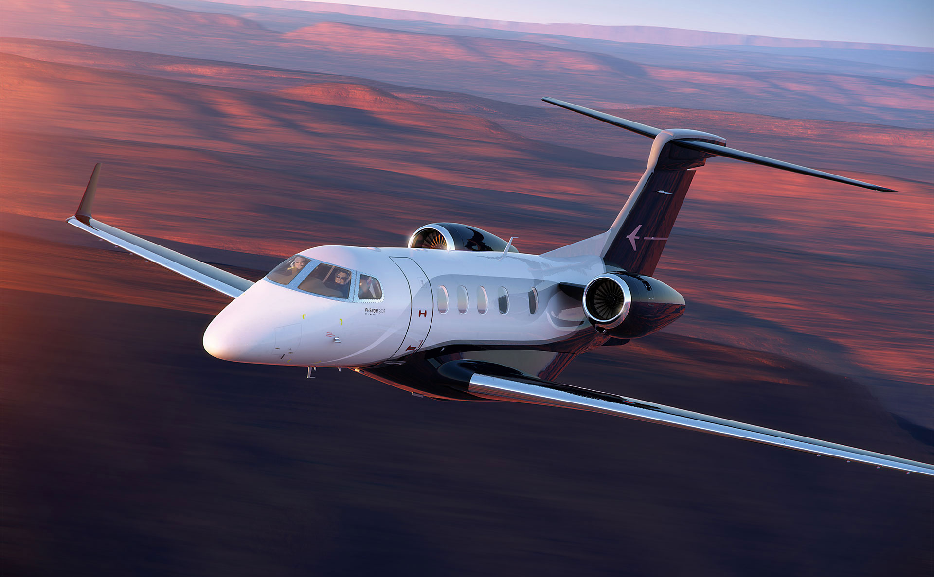 Embraer Phenom 300 flying into the sunset