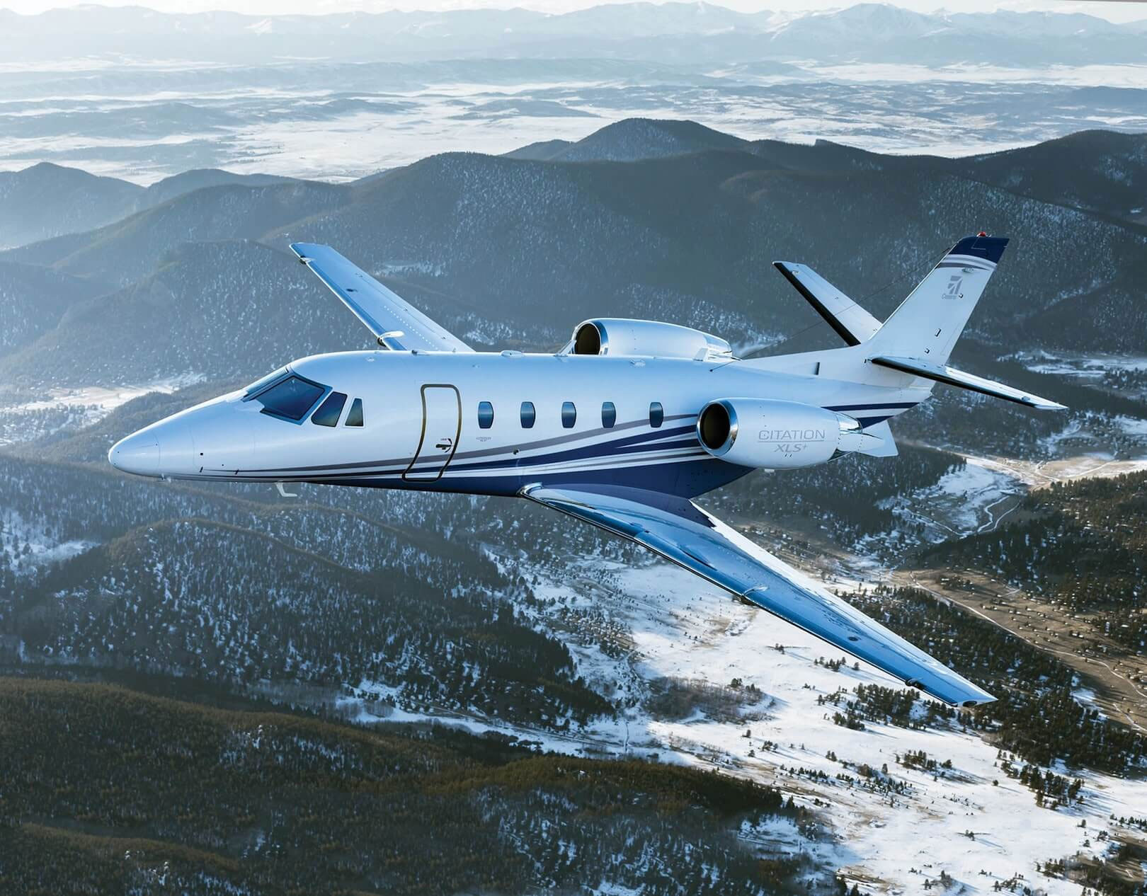 Cessna Citation Excel XLS flying over snow mountains