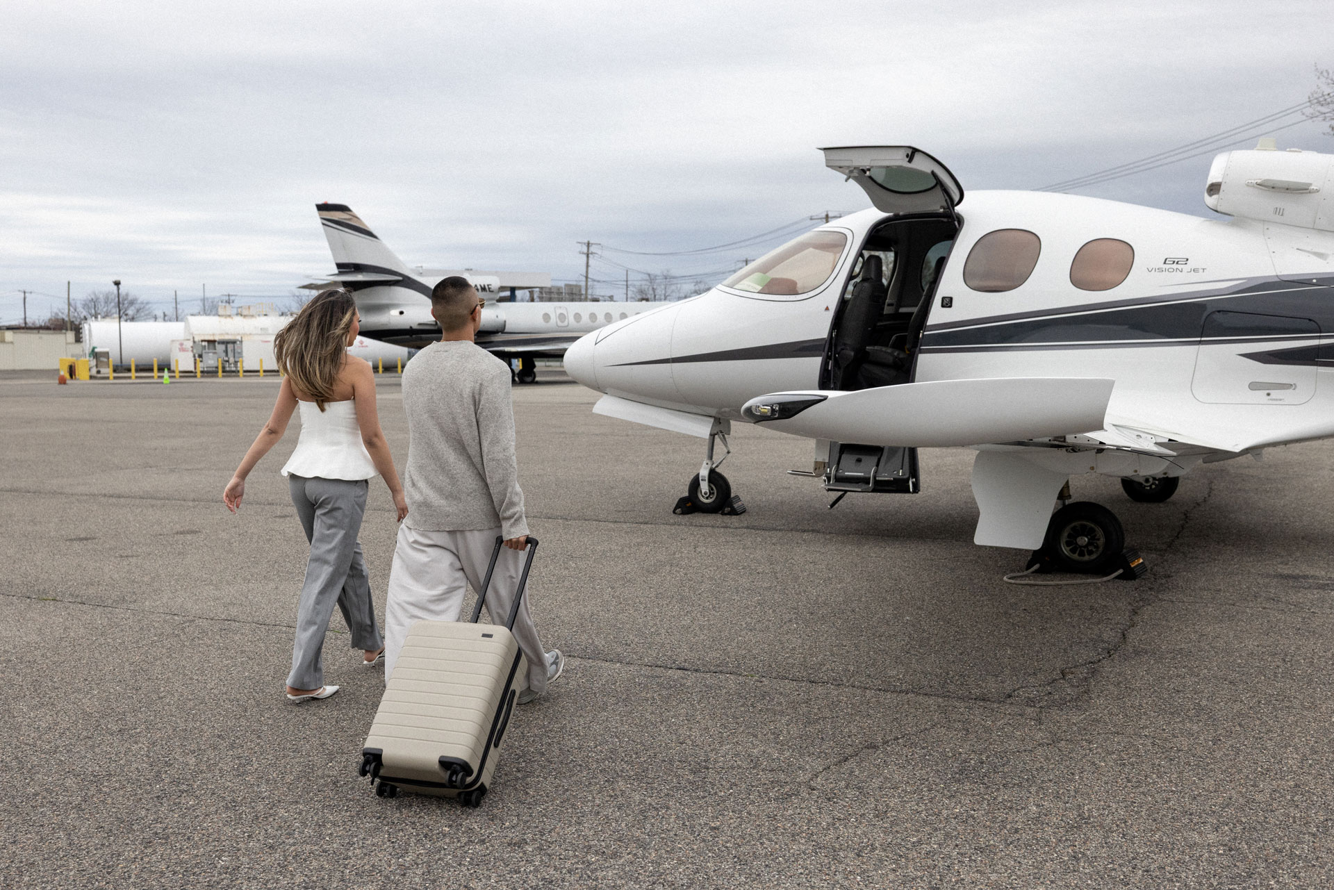 Couple boarding cirrus vision jet